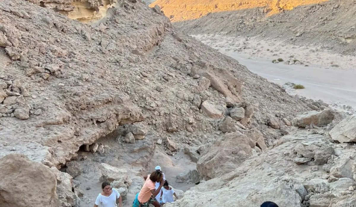 Adventurers enjoying a desert canyon hike in El Gouna at sunset